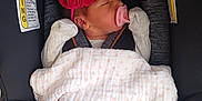 Jazmine Serenity joined the competition — help win amazing prizes! baby, newborn, car_seat, pacifier, headband, red_bow, blanket, polka_dots, floral_pattern, sleeping, infant, child, clothing, seatbelt, closeup, indoors, comfort, safe, cute, resting