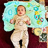 baby, infant, child, toy, blanket, carpet, floor, play, cute, clothing, elephant, rattle, yellow, blue, pattern, smile, face, hand, foot, indoors