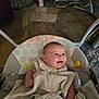 Evee is registered to the contest to win money with this photo: baby, smiling, blanket, baby_swing, infant, indoors, floor_tiles, carpet, happy, person, child, seat, straps, clothing, cute, head, face, comfort, resting, home