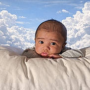 Adonais is registered to the contest to win money with this photo: baby, infant, pillow, face, clouds, sky, resting, cute, portrait, child, soft, comfort, expression, young, indoors, clothing, head, looking, relaxing, peaceful