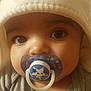 baby, pacifier, hat, face, closeup, infant, child, cute, indoors, apparel, expression, person, portrait, skin, clothing, babywear, headwear, eyes, nose, mouth