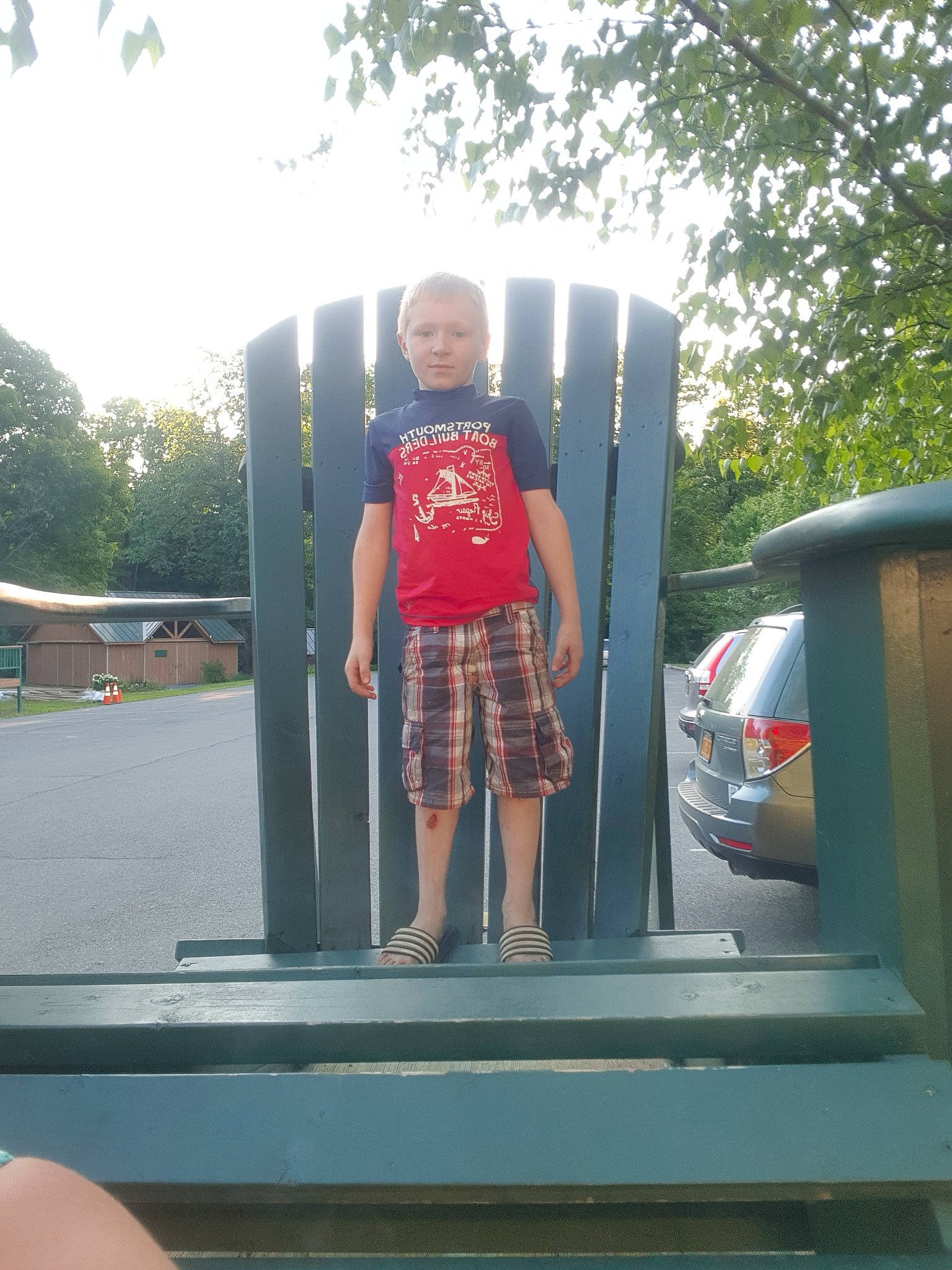 Josiah is registered to the contest to win money with this photo: automotive_exterior, car, person, shorts, snapshot, standing, summer, tree, vacation, vehicle