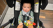 Evelyn joined the competition — help win amazing prizes! baby, infant, child, swing, toy, bee, pink_socks, floor, wooden_wall, tile_floor, clothing, smiling, indoor, seat, straps, footwear, person, cute, happy, portrait