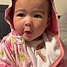 baby, child, hoodie, pink_clothing, animal_print, indoor, face, expression, cute, infant, portrait, clothing, young_child, apparel, person, casual, warm, cozy, sitting, hood