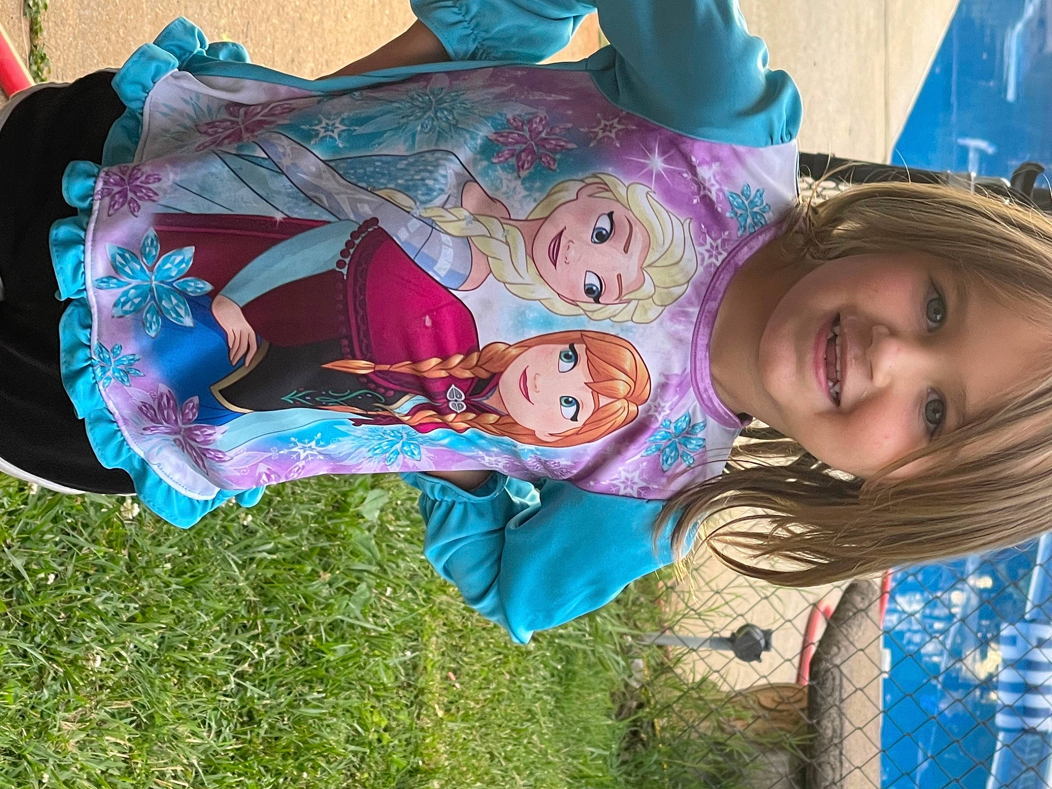 Ava is registered to the contest to win money with this photo: art, blue, child, cool, event, fun, grass, happy, joy, leisure, magenta, mouth, painting, person, pink, plant, public_space, purple, recreation, smile