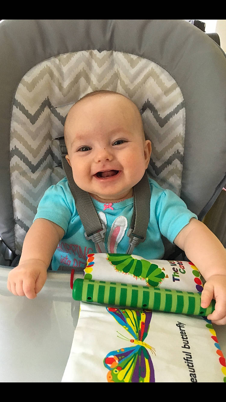 Ellison is registered to the contest to win money with this photo: baby, baby_products, baby_toddler_clothing, cheek, child, head, person, play, product, skin, smile, toddler, tummy_time