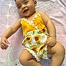 baby, child, smile, cute, romper, sunflower, yellow, blanket, elephant, stars, pastel, infant, happy, lying_down, soft_texture, cheerful, portrait, indoors, skin, head