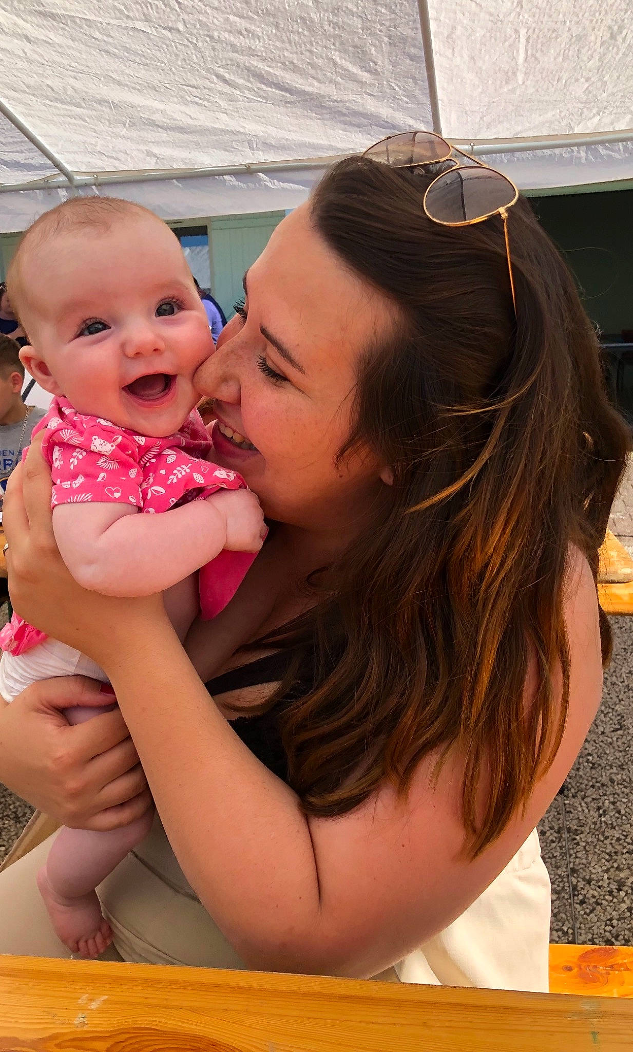 évie a rejoint le concours — aidez-le/la à gagner de superbes lots ! arm, baby, blond, child, event, fun, gesture, grass, happy, hug, jewellery, leisure, lip, love, mouth, person, sitting, skin, smile, toddler