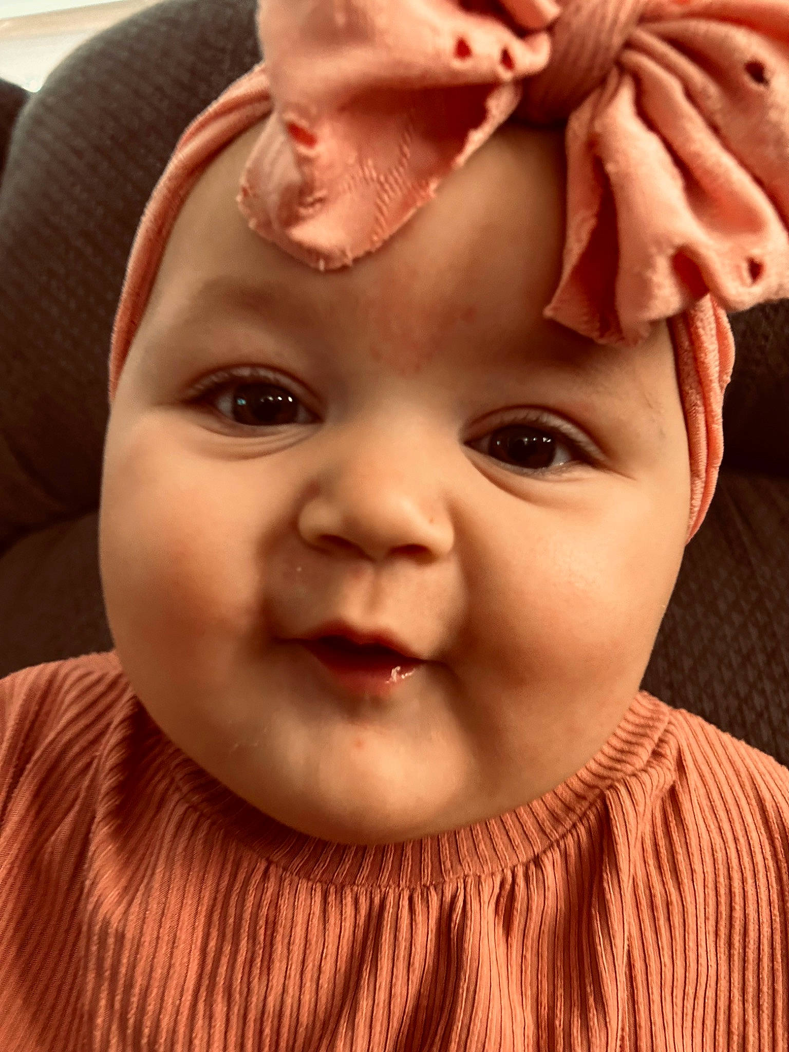 Ella is registered to the contest to win money with this photo: baby, baby_toddler_clothing, cheek, ear, eye, eyebrow, eyelash, face, forehead, hair, happy, head, headwear, human_body, jaw, lip, mouth, nose, person, plant