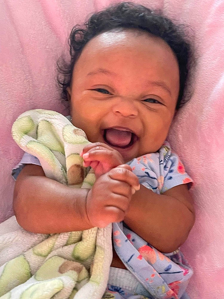 Amaia is registered to the contest to win money with this photo: baby, baby_toddler_clothing, cheek, child, comfort, event, finger, fun, gesture, happy, lip, mouth, nose, organ, person, photograph, skin, smile, textile, thumb