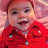 baby, smiling, red_jacket, cap, blanket, outdoor, happy, face, child, infant, portrait, cute, clothing, button, cheeks, sunlight, closeup, person, headwear, warm