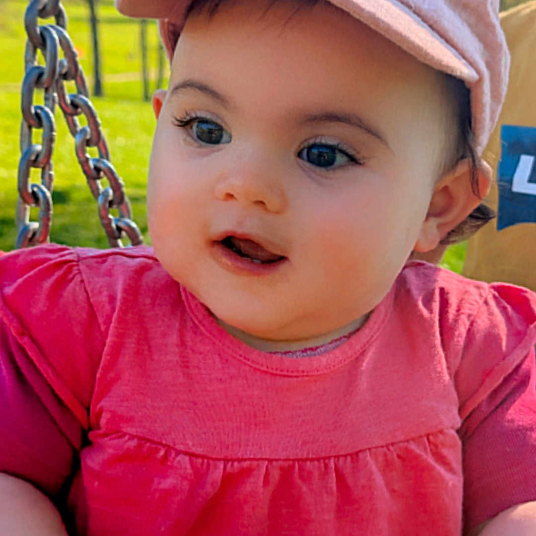 élaïa participe au concours pour gagner de l'argent avec cette photo : baby, child, outdoor, park, swing, pink_clothing, hat, bunny_ears, grass, sunlight, face, hands, curious, cute, infant, nature, playground, daylight, person, portrait