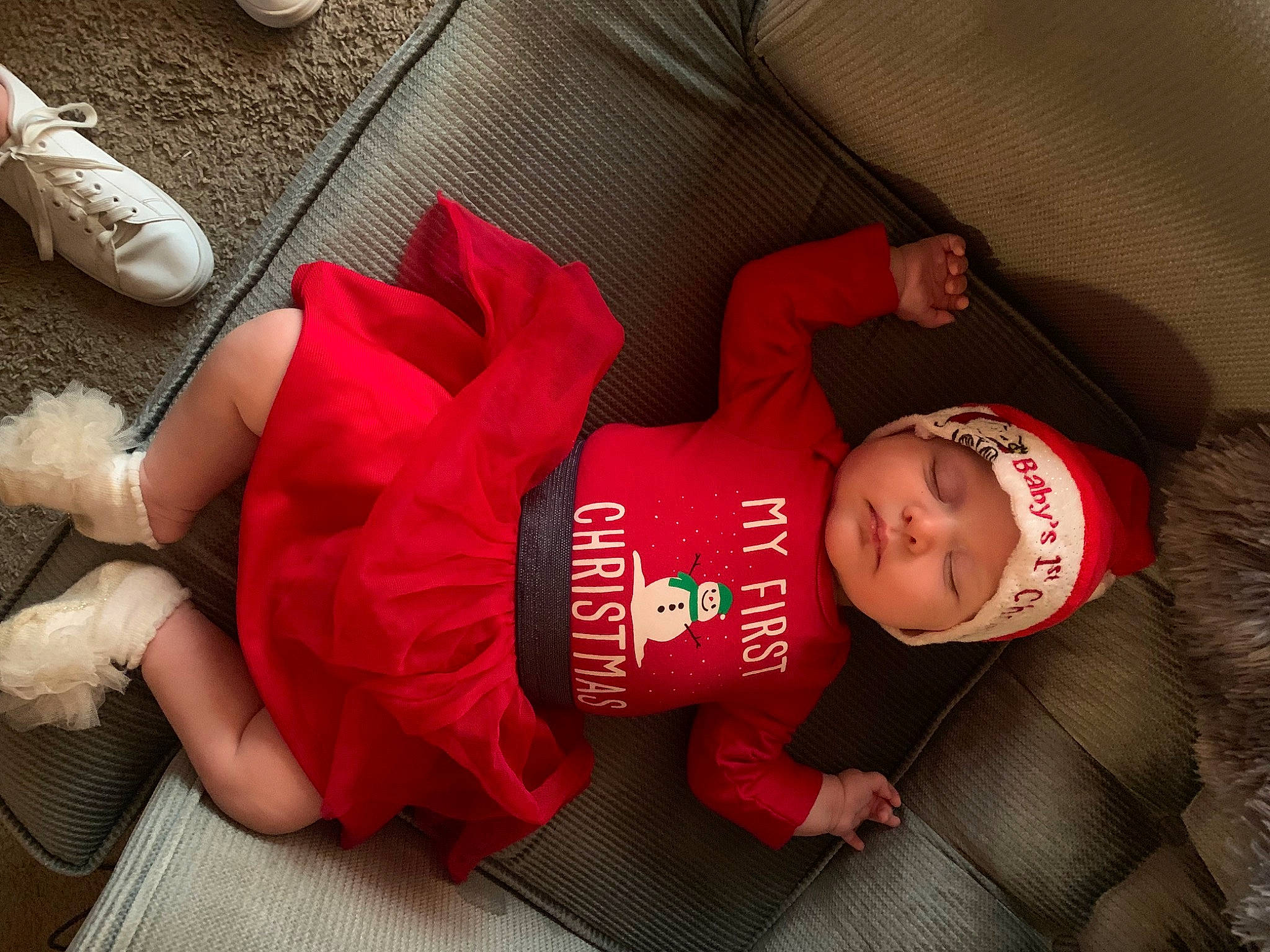 Adelaide joined the competition — help win amazing prizes! baby, baby_toddler_clothing, carmine, comfort, finger, flooring, foot, fun, glasses, hat, headwear, human_leg, knee, lap, person, red, sleeve, smile, thigh, toddler