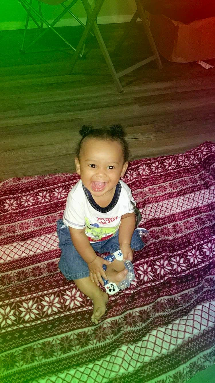 Sir is registered to the contest to win money with this photo: baby, baby_products, baby_toddler_clothing, child, eye, foot, joy, linens, mouth, nose, pattern, person, quilt, sandal, sock, textile, thread, toddler