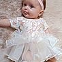 éloïse a rejoint le concours — aidez-le/la à gagner de superbes lots ! accessories, baby, bodypart, clothing, dress, face, fashion, finger, flower, formalwear, gown, hand, head, headband, newborn, person, photography, plant, portrait, sitting