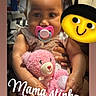 baby, pacifier, teddy_bear, pink, braided_hair, child, plush_toy, sitting, cute, indoors, holding, person, hand, face, smile, sock, furniture, background, emoji, text_overlay