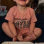 toddler, child, smiling, food, messy_face, indoor, cross_legged, shirt, takeout_container, rice, beans, curly_hair, happy, meal, plate, sitting, cute, baby, clothing, person
