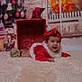 baby, infant, red_clothing, headband, smiling, christmas_tree, holiday_decor, snowman, fireplace, gift_box, carpet, indoor, festive, cute, portrait, tummy_time, decorations, happy, child, christmas