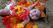 Hallie joined the competition — help win amazing prizes! adorable, autumn_leaves, baby, child, chubby, closeup, colorful, cute, diaper, fall, furry_rug, headband, indoor, infant, laying_down, orange_bow, portrait, seasonal, skin, soft_texture