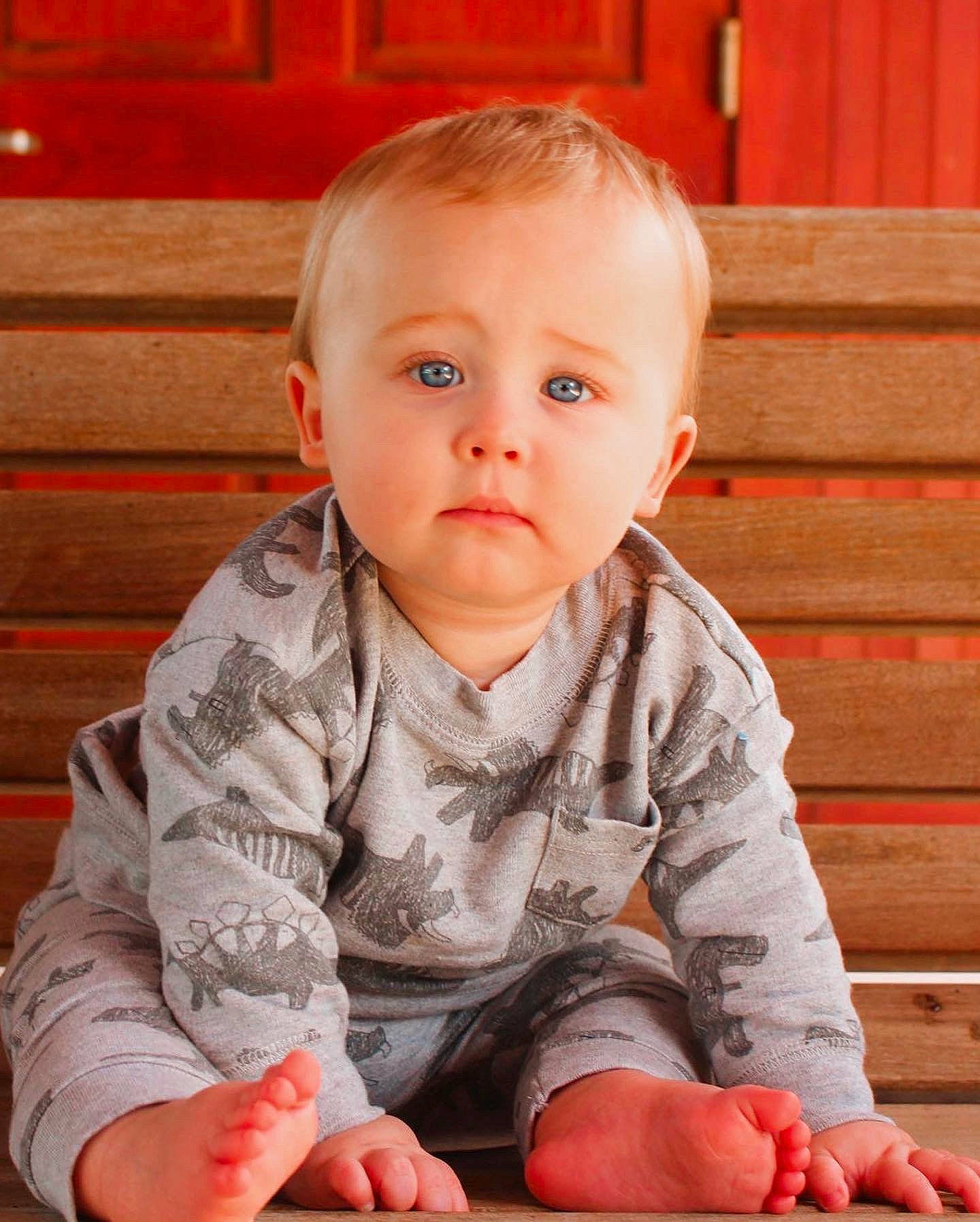 Calvin joined the competition — help win amazing prizes! arm, baby, baby_toddler_clothing, cheek, child, close_up, eye, face, floor, flooring, head, iris, nose, orange, person, sitting, skin, sleeve, standing, toddler