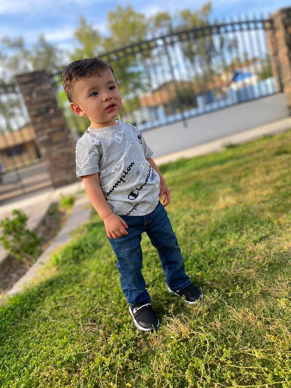 Alejandro joined the competition — help win amazing prizes! child, denim, footwear, fun, grass, grassland, happy, jeans, landscape, leisure, people_in_nature, person, plant, recreation, shoe, sitting, sky, sunlight, t_shirt, toddler