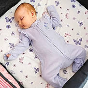 Josette is registered to the contest to win money with this photo: baby, sleeping, onesie, lavender, butterfly, pattern, crib, playpen, infant, child, soft, peaceful, cute, resting, bed, fabric, pajamas, toddler, nursery, calm