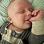 Liam is registered to the contest to win money with this photo: baby, smiling, sleeping, thumb_sucking, striped_clothing, infant, close_up, face, hand, blanket, cozy, comfort, cute, child, portrait, indoor, soft_lighting, peaceful, young, resting