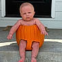 baby, pumpkin, porch, step, outdoor, expression, face, legs, feet, skin, door, concrete, holiday, fall, costume, child, sitting, front_door, funny, cute
