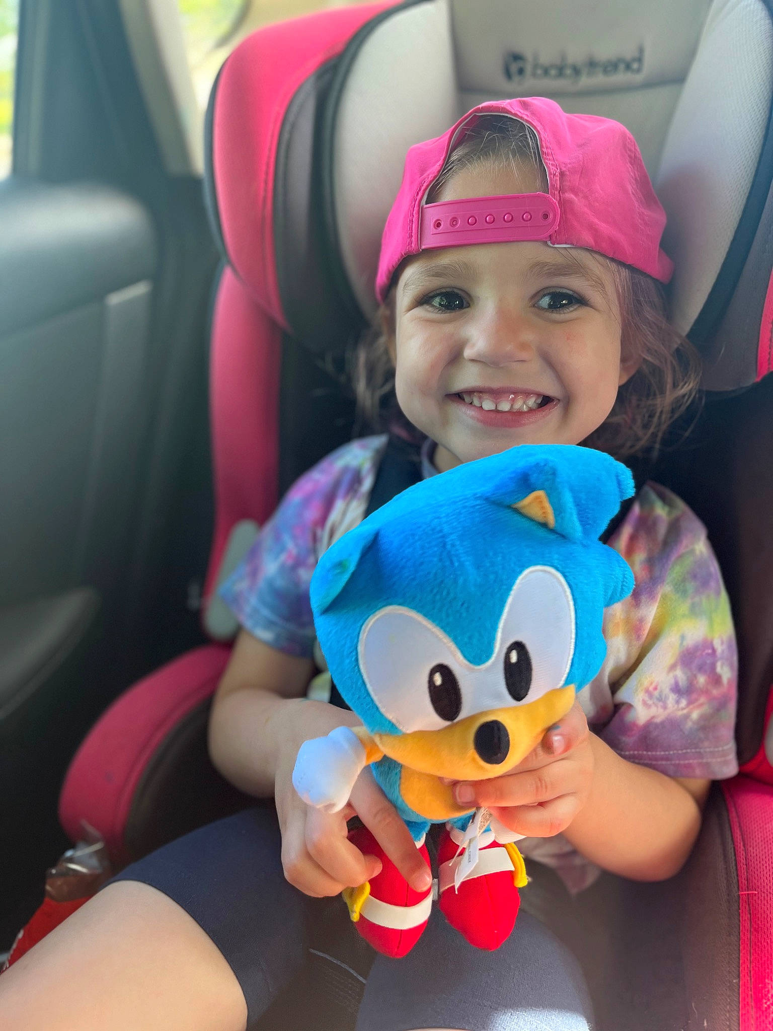 Taytum joined the competition — help win amazing prizes! auto_part, car, car_seat, car_seat_cover, child, cool, facial_expression, finger, fun, happy, head_restraint, headwear, joy, person, pink, skin, smile, snapshot, steering_wheel, toddler