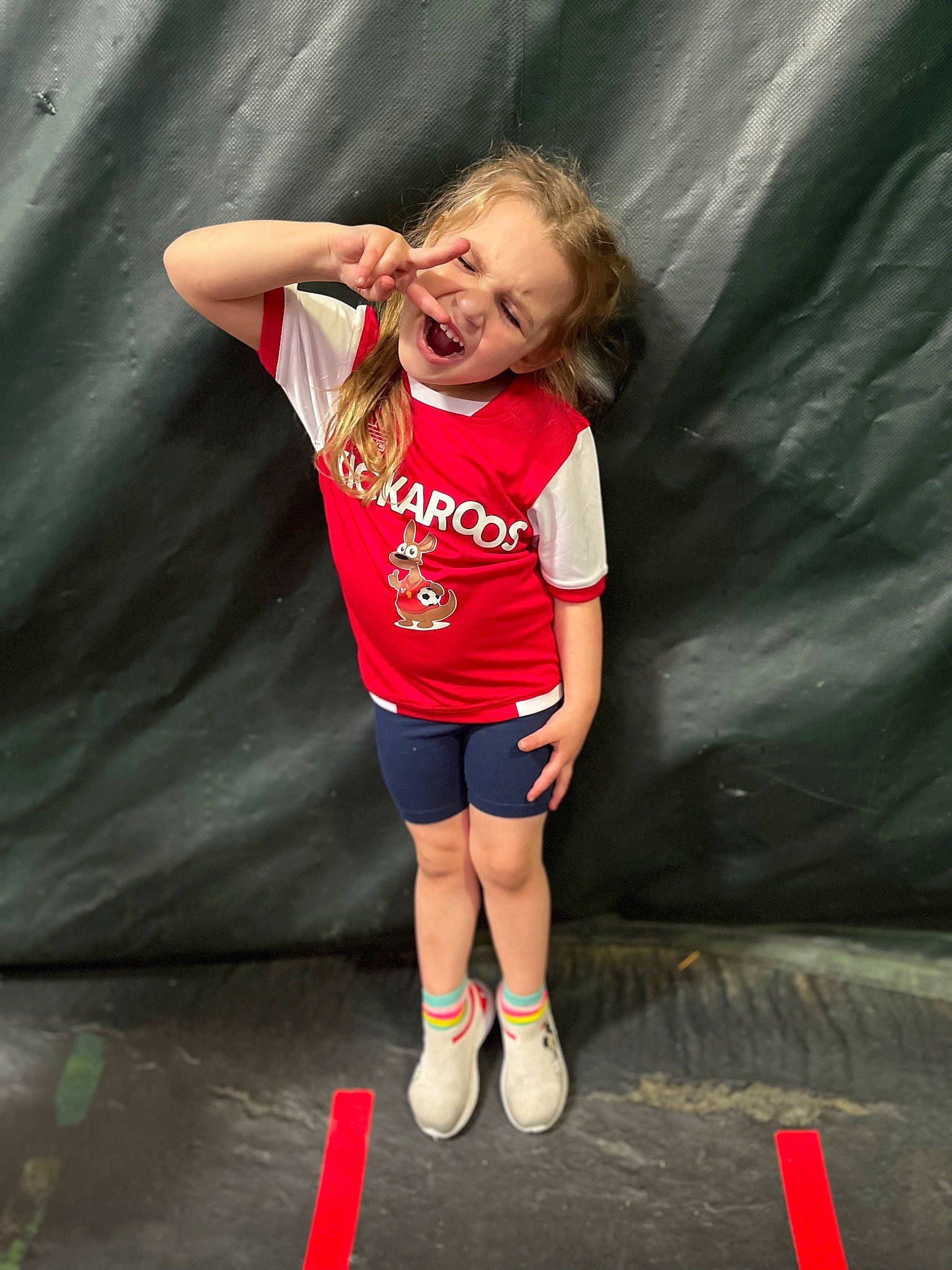 Taytum is registered to the contest to win money with this photo: cool, event, eye, fashion, flash_photography, fun, happy, human_leg, joint, knee, leisure, organ, person, recreation, shorts, smile, sportswear, t_shirt, thigh, toddler