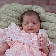 Aurora-Rose is registered to the contest to win money with this photo: baby, newborn, infant, pink_dress, lace, blanket, sleeping, peaceful, soft_texture, closeup, portrait, cute, child, resting, indoors, human, small_hands, face, head, cozy