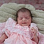 baby, newborn, infant, pink_dress, lace, blanket, sleeping, peaceful, soft_texture, closeup, portrait, cute, child, resting, indoors, human, small_hands, face, head, cozy