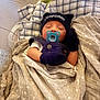 Giovanni is registered to the contest to win money with this photo: baby, newborn, pacifier, blanket, hat, mittens, sleeping, crib, fabric, pattern, soft, cozy, infant, resting, cute, child, bed, comfort, person, indoors