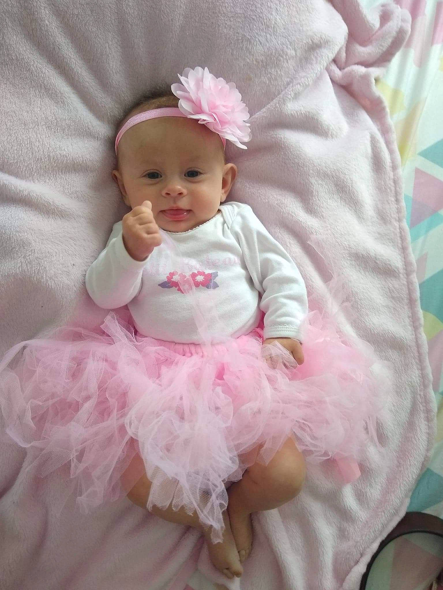 Leyna participe au concours pour gagner de l'argent avec cette photo : baby, baby_toddler_clothing, child, dress, embellishment, fashion_accessory, hair_accessory, headband, headgear, headpiece, linens, magenta, pattern, person, pink, product, ruffle, sleeve, smile, textile