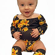 Krimson is registered to the contest to win money with this photo: baby, child, infant, smile, headband, bow, floral_outfit, socks, sitting, portrait, cute, happy, fashion, clothing, one_person, studio, white_background, young_child, face, apparel