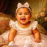 Josiris Isarel is registered to the contest to win money with this photo: adorable, baby, bow, celebration, child, chubby_cheeks, cute, dress, elegant, floral_backdrop, girl, happy, headband, indoors, pearl, pink_dress, portrait, sitting, smiling, vintage_sofa