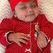 Josiris Isarel is registered to the contest to win money with this photo: baby, infant, sleeping, red_headband, red_clothing, polka_dots, hand, blanket, cute, indoors, portrait, child, soft_texture, peaceful, toddler, headwear, cozy, sleep, small_baby, holiday