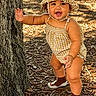 Josiris Isarel is registered to the contest to win money with this photo: child, toddler, hat, yellow, romper, tree, outdoor, nature, walking, sunlight, smiling, happy, baby, footwear, leaves, ground, person, cute, summer, playful