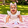 Josiris Isarel is registered to the contest to win money with this photo: baby, blanket, bow, child, cute, daytime, flower, garden, grass, happy, headband, infant, nature, outdoor, pink_dress, portrait, sitting, smiling, sunlight, young_child