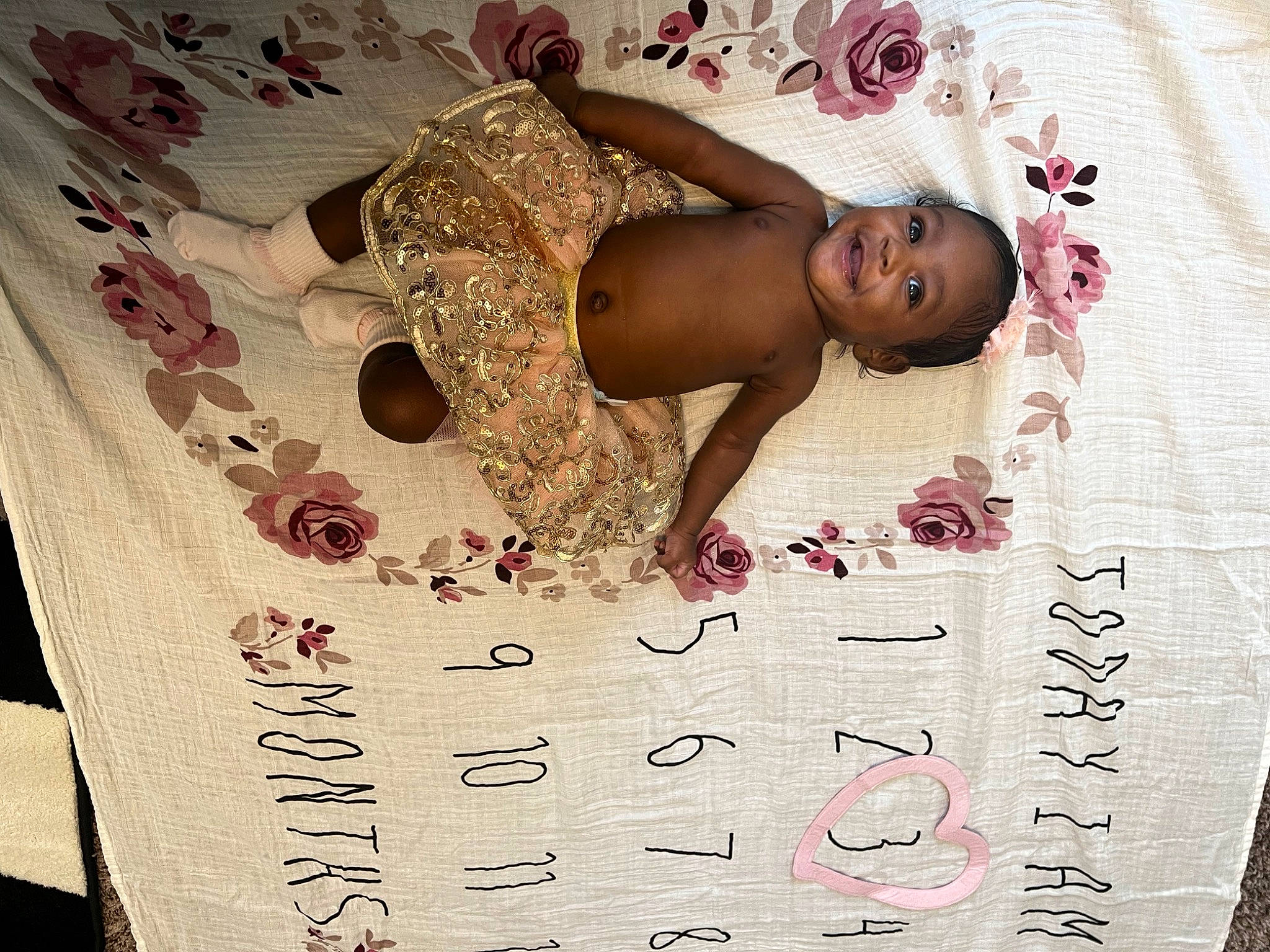 Amiri is registered to the contest to win money with this photo: baby, child, comfort, fashion_design, flesh, flooring, font, happy, joy, linens, number, paper, pattern, person, petal, plant, visual_arts, writing