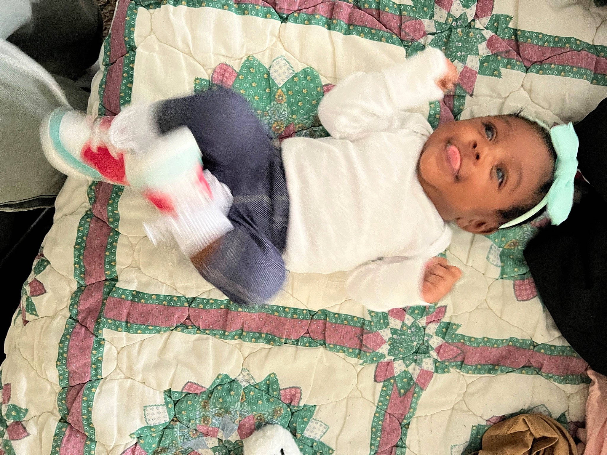 Amiri is registered to the contest to win money with this photo: baby, baby_products, baby_toddler_clothing, bedding, child, comfort, event, eye, green, head, joy, linens, pattern, person, red, room, sleeve, smile, tablecloth, textile