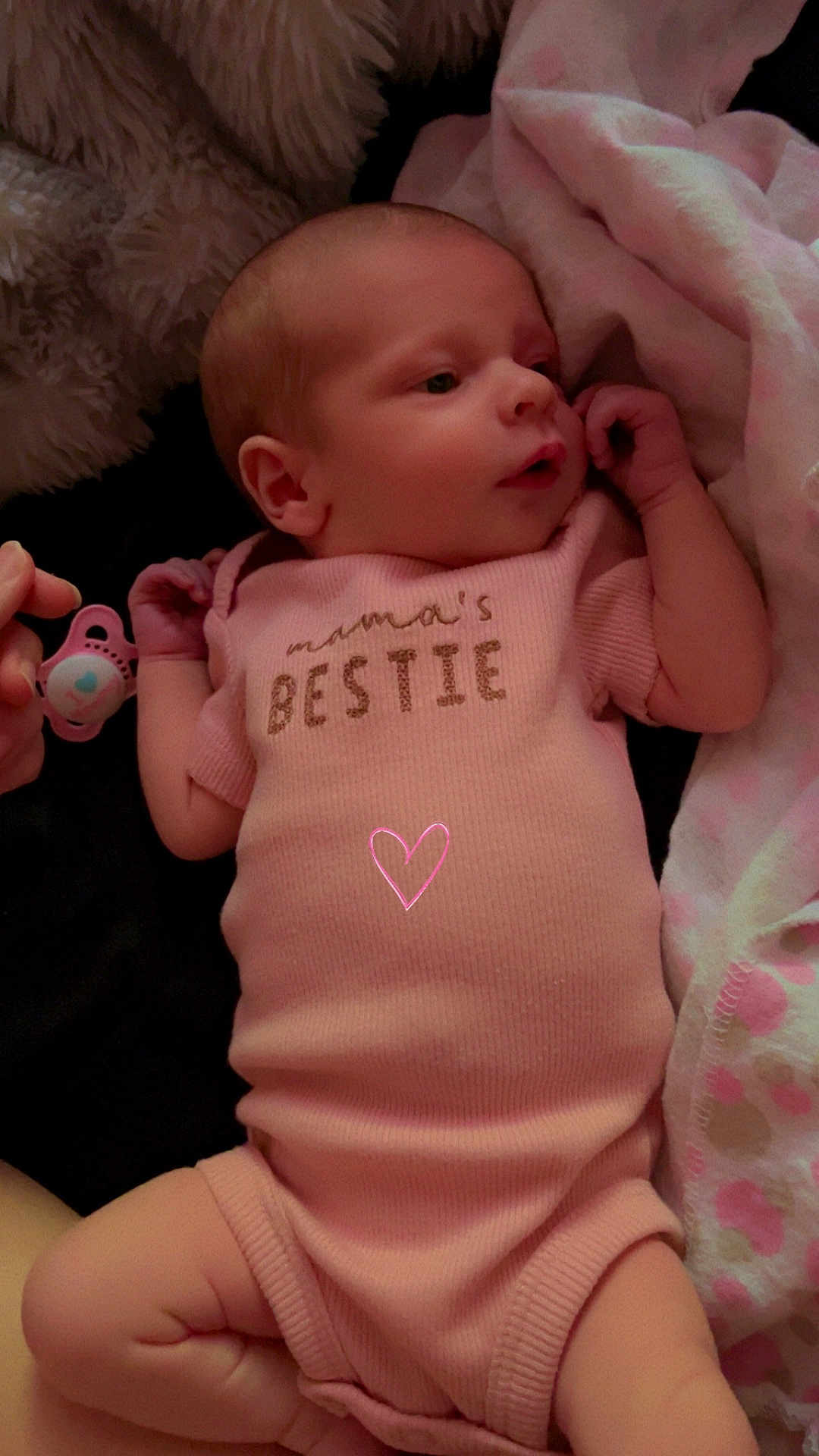 Wrenley is registered to the contest to win money with this photo: baby, infant, onesie, pink_clothing, pacifier, blanket, soft_texture, lying_down, cute, newborn, child, sleepwear, resting, face, hand, foot, indoor, comfort, adorable, peaceful