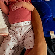 Wrenley joined the competition — help win amazing prizes! baby, infant, person, arm, hand, clothing, sock, plush_toy, blue, pink, white, patterned_pants, cute, indoor, relaxed, holding, lying_down, skin, face, toy