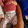 baby, infant, person, arm, hand, clothing, sock, plush_toy, blue, pink, white, patterned_pants, cute, indoor, relaxed, holding, lying_down, skin, face, toy