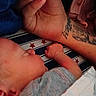 Tyson joined the competition — help win amazing prizes! arm, baby, blanket, closeup, cuddling, hand, human, indoor, infant, newborn, peaceful, person, resting, skin, sleep, sleeping, soft, stars, striped, tattoo