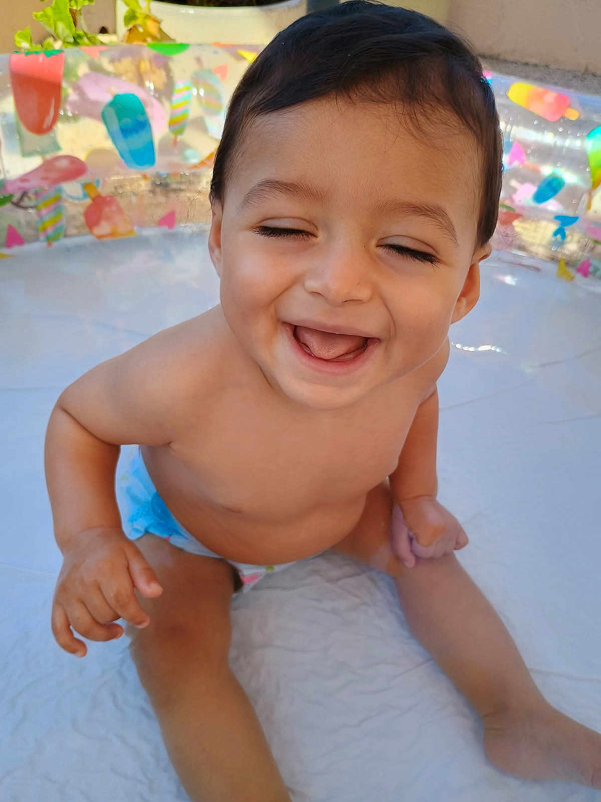 Lisandro participe au concours pour gagner de l'argent avec cette photo : baby, child, smiling, laughing, diaper, pool, inflatable_pool, water_toy, summer, outdoor, sunlight, happy, cute, skin, face, hand, legs, play, fun, toddler