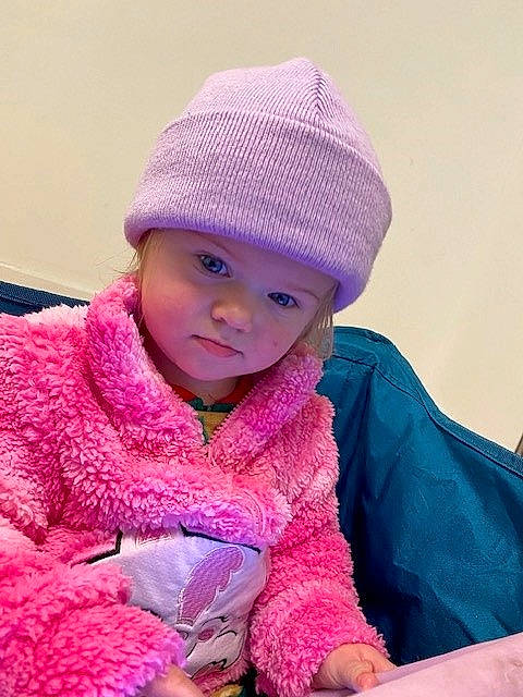 Sadie is registered to the contest to win money with this photo: baby, baby_toddler_clothing, beanie, cap, cheek, child, comfort, electric_blue, fun, headgear, headwear, jacket, knit_cap, magenta, person, pink, purple, sleeve, toddler, violet
