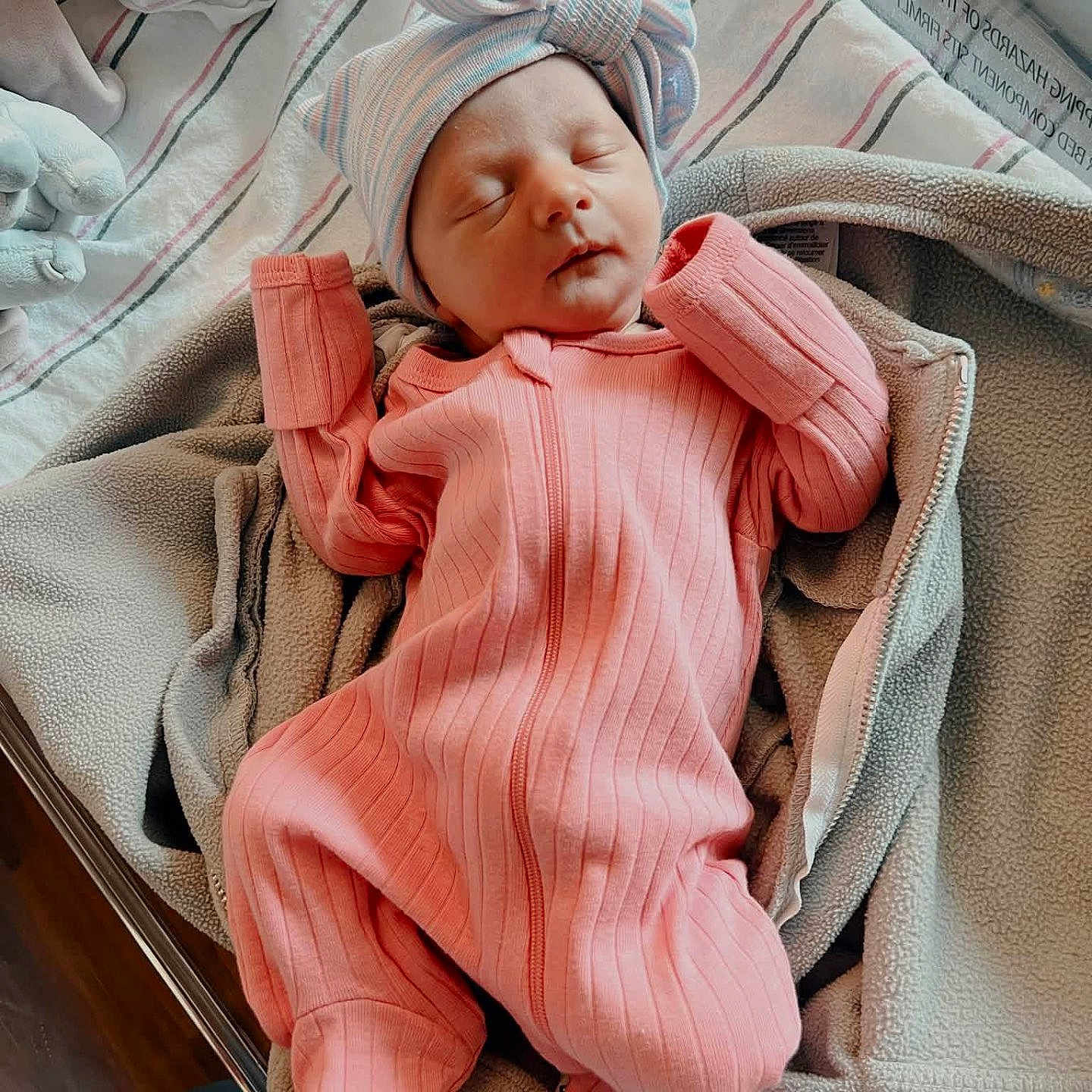 Victoria is registered to the contest to win money with this photo: newborn, baby, sleeping, pink_outfit, bow_hat, blanket, hospital_bassinet, cozy, infant, child, bed, soft_texture, portrait, indoors, peaceful, cute, wrapped, clothing, person, rest