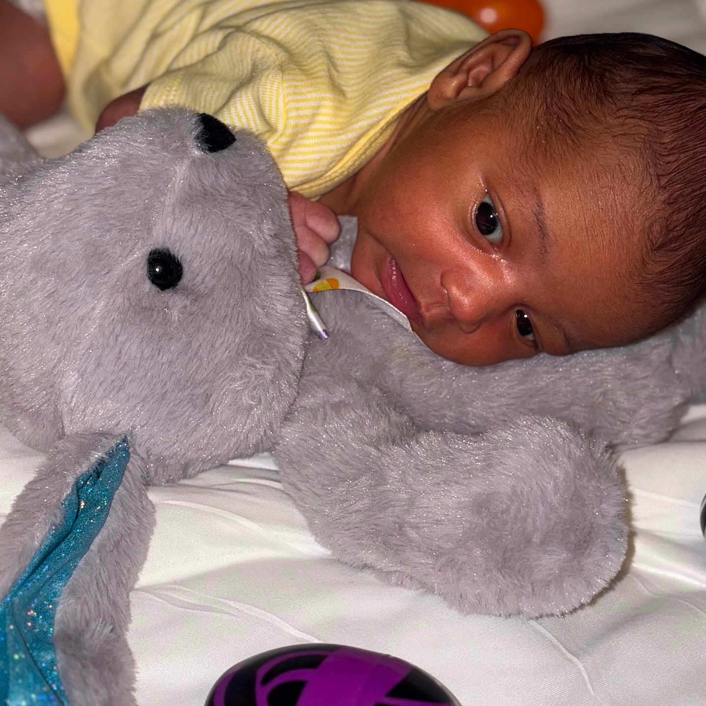 Enzo is registered to the contest to win money with this photo: baby, ball, bodypart, couch, face, finger, football, furniture, hand, head, helmet, homedecor, newborn, person, photography, portrait, soccer, soccerball, sport, toy