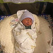 Braxton joined the competition — help win amazing prizes! newborn, baby, sleeping, swaddled, blanket, hat, pillow, bear_pattern, giraffe_pattern, crib, playpen, infant, resting, soft_texture, cozy, indoor, child, cute, peaceful, nursery